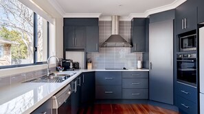 Enjoy cooking in this well-equipped kitchen with an oven, double sink, and dishwasher.