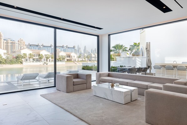 Exclusive Villa, 5 Bedrooms, Private Pool, Beachfront | Living area | 75-inch LED TV with satellite channels, TV, fireplace - Palm Paradise- 5BR Villa - Infinity Pool (Dubai)