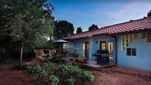 A house with a red-tiled roof, a patio with outdoor furniture, and a barbecue grill. - Red Rock Views, Hot Tub, Community Pool, Walk To Pickleball Court, Trail Pass (Sedona)