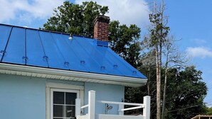 A light blue house with a white fence, a window, and a blue roof. - Charming Cottage - Northeast River / Chesapeake Bay (Perryville)