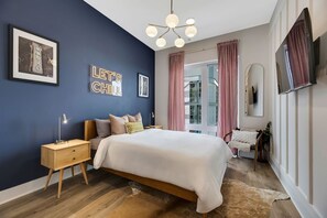 A modern bedroom with a large bed, bedside tables, a TV, and a city view. - Johnny Cash on Main | 1 mile to DTNash|  LUX! (Nashville)