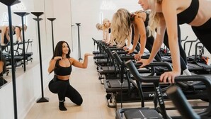 A fitness studio with treadmills and mirrors.