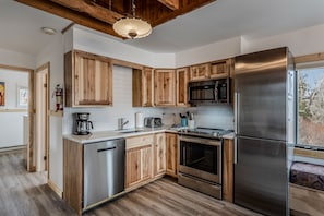 Enjoy cooking in this well-equipped kitchen with a dishwasher, oven, microwave, and large refrigerator.