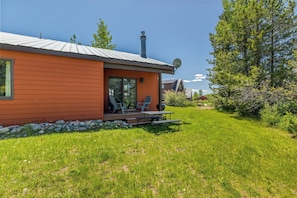 A single-story house with a sloped roof, a satellite dish, and a patio with outdoor furniture.