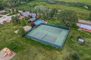 An aerial view of a residential area with a tennis court, houses, and a swimming pool. - Wintersong - Near lakes, trails, and horses! (Clark)
