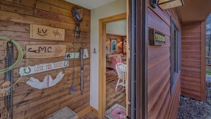 A wooden cabin interior with a mounted sign reading "Fireside," a horse head decoration, and a sign indicating "Lost Your Shoes." - Fireside - Quaint cabin near hiking and fishing (Clark)