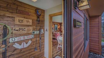 A wooden cabin interior with a mounted sign reading "Fireside," a horse head decoration, and a sign indicating "Lost Your Shoes."
