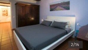 A single bed with a headboard, a wooden wardrobe, and a painting on the wall. - Vaticanhouse  (Roma)