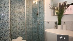 A bathroom with a glass shower enclosure, a white sink, and a mirror above the sink. - Vaticanhouse  (Roma)