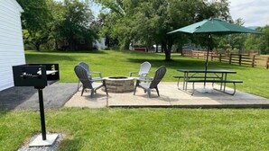 A backyard with a fire pit, two Adirondack chairs, a picnic table, and a mailbox. - Country View Cottage-Near Massanutten, Skyline drive,&JMU.A home away from home! (Elkton)