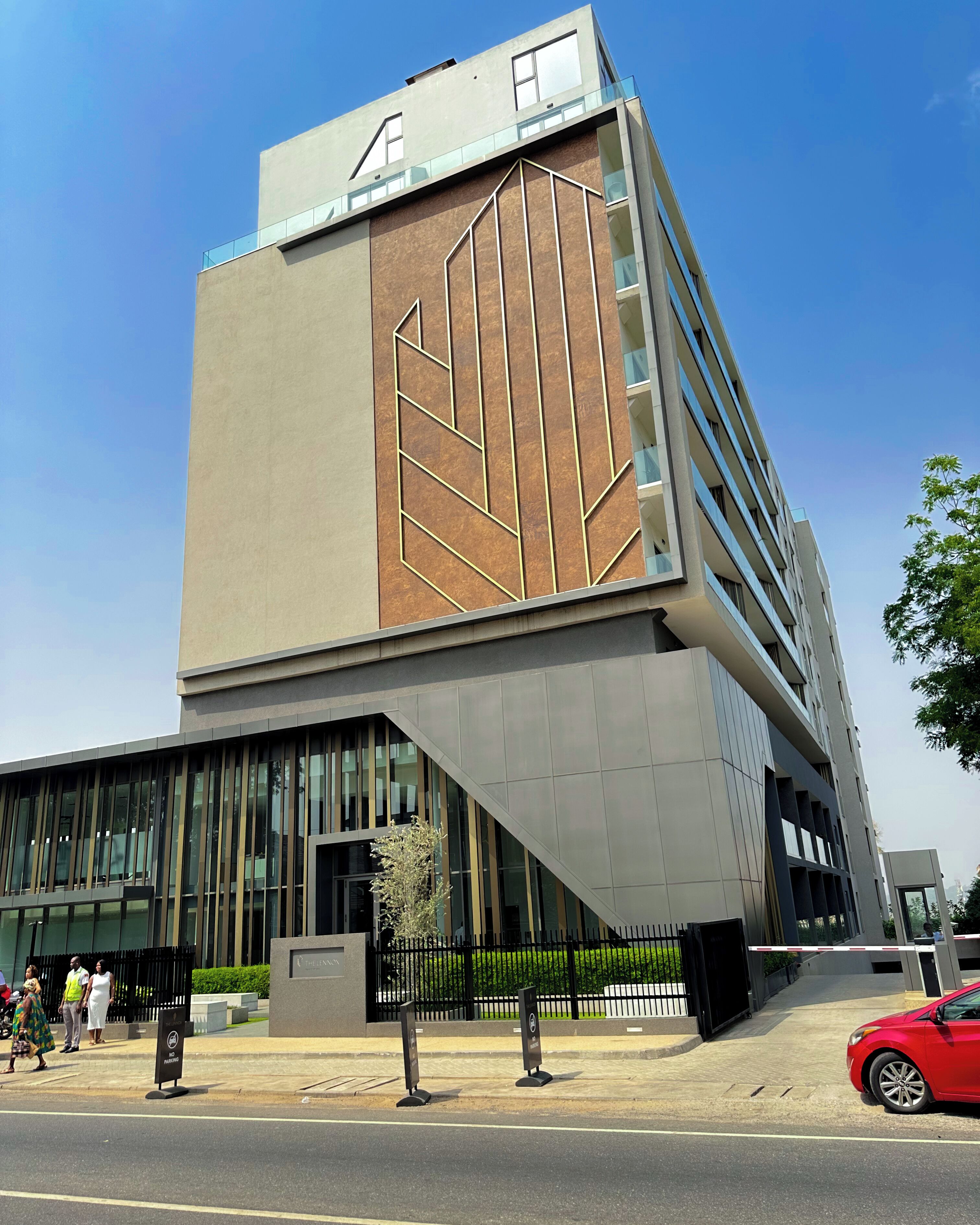 A modern building with a prominent geometric facade, large windows, and a visible entrance area.