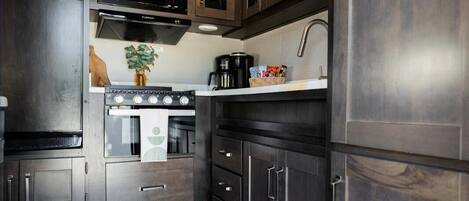 Fridge, microwave, coffee/tea maker, cookware/dishes/utensils