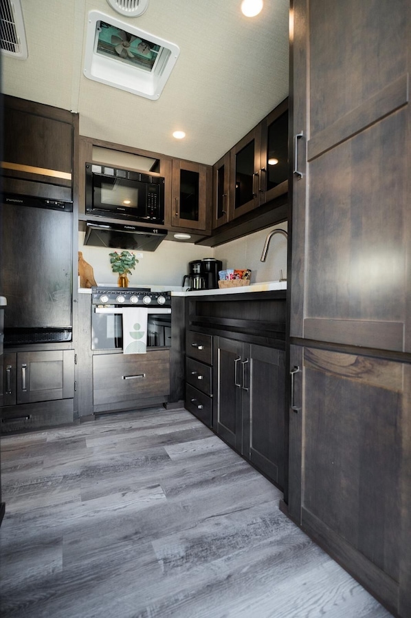 Fridge, microwave, coffee/tea maker, cookware/dishes/utensils