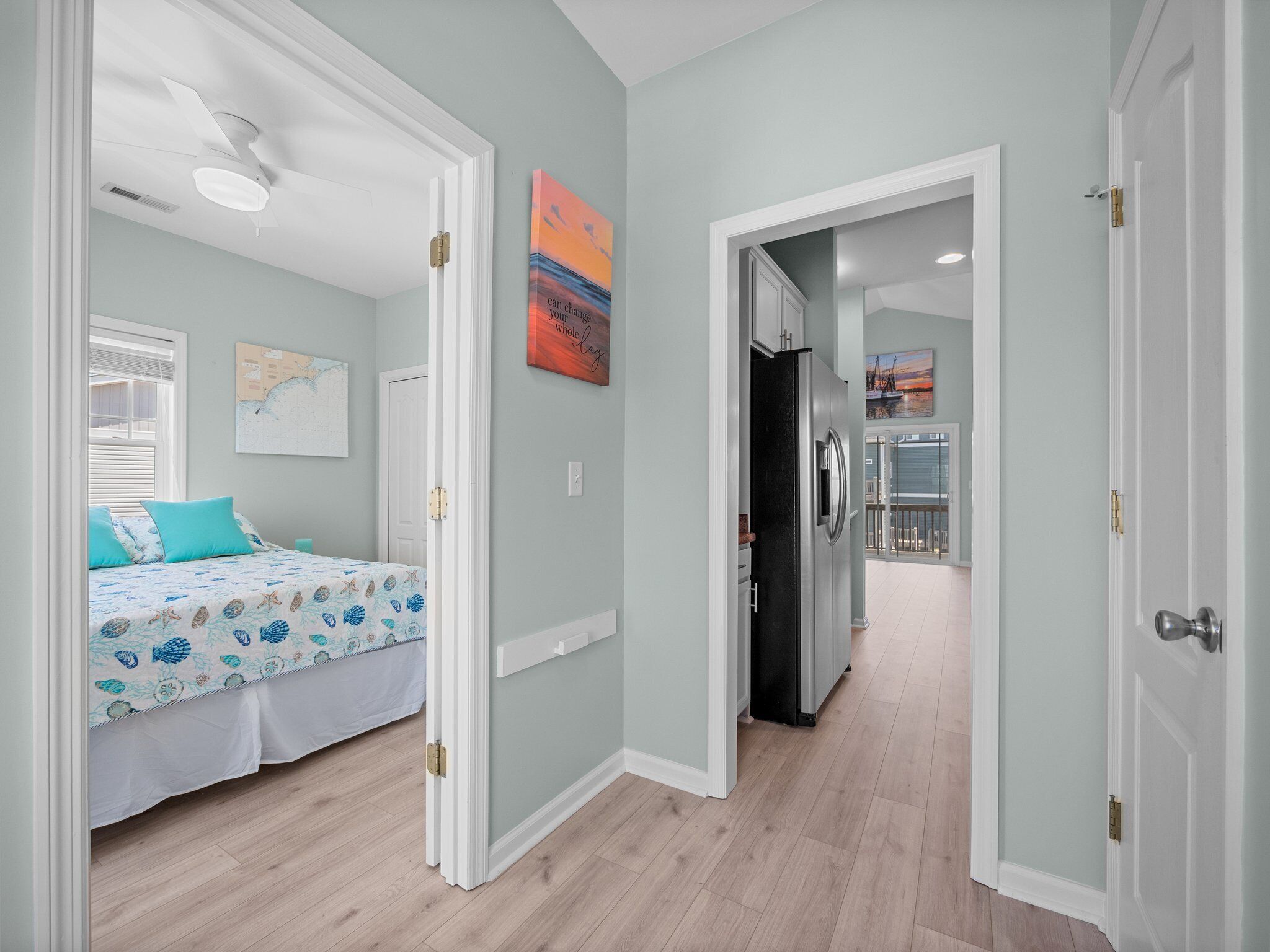 Un dormitorio con cama, ventilador de techo y ventana.