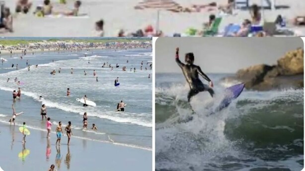 A crowded beach with a large crowd, a church in the background, and a surfer riding a wave. - Spacious, comfortable rooms near beach & Newport (Middletown)