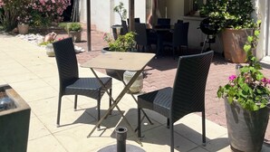 An outdoor patio with a table and chairs, a pergola, and potted plants. - A peaceful haven with swimming pool, 20 minutes from Bordeaux and its vineyards. (TRESSES)