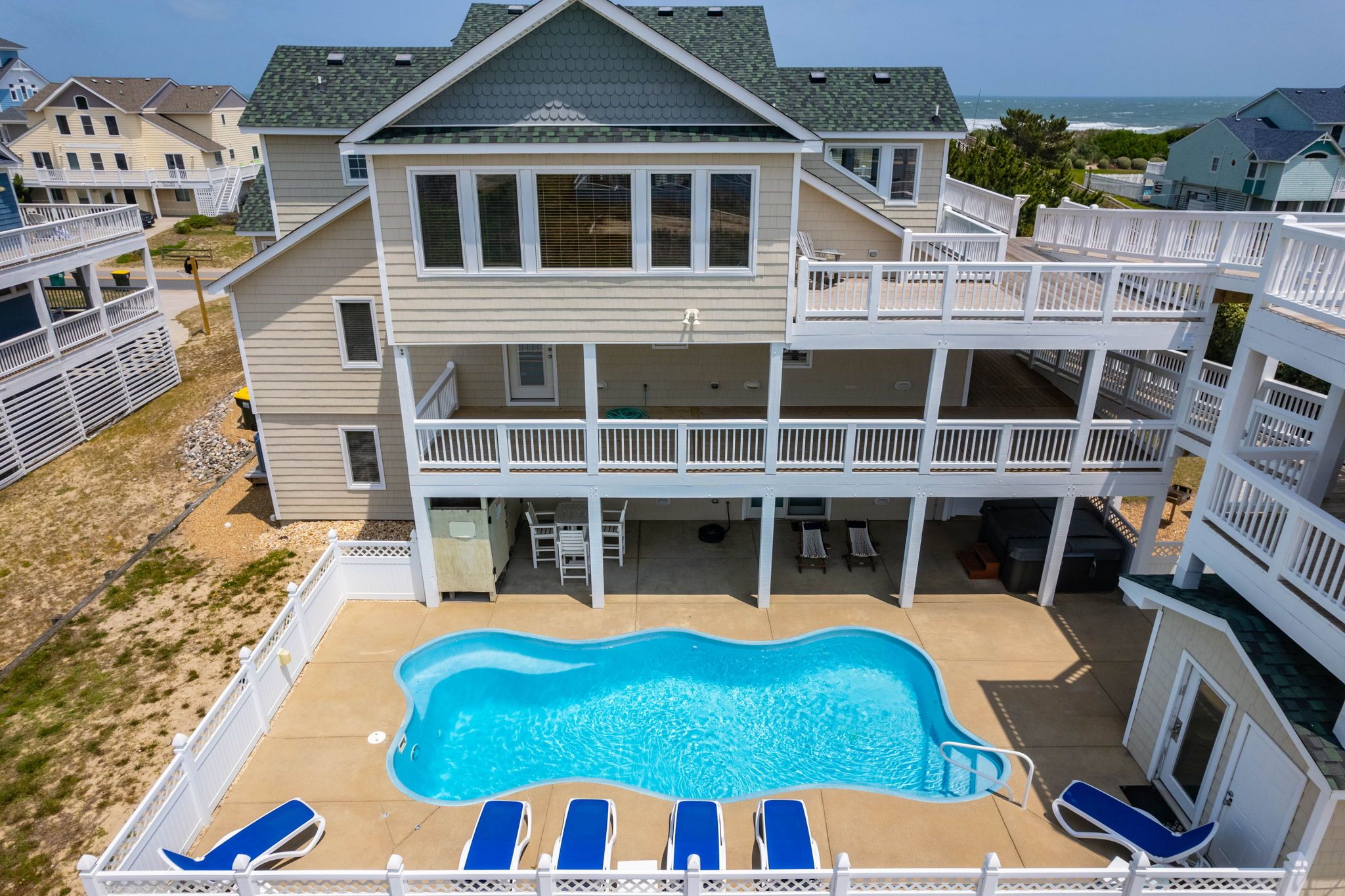 A multi-story building with a swimming pool and outdoor seating.