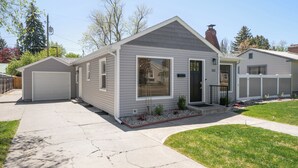 A single-story house with a garage, a front porch, and a small front yard. - Remodeled home with vintage charm. Centrally located near downtown Idaho Falls. (Idaho Falls)
