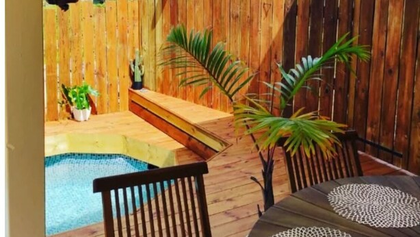 A backyard with a wooden deck, a small pool, and outdoor furniture. - Villa Kajoane, deluxe villa south of martinique close to beautiful beaches (Fort de France)