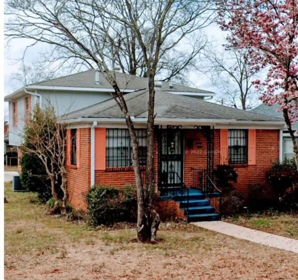 Stunning two-story home with a charming front entrance and a beautifully manicured lawn.