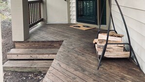 A wooden deck with a door and a window, leading to a covered porch area. - Beautiful Camelback Views, Mountain - New Renovated 3-Bed / 2-bath home (Tannersville)