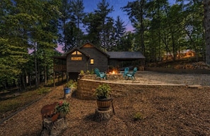 A cabin with a fire pit, outdoor seating, and a stone wall. - Blue Ridge, GA - Cozy Mountain Cabin (Morganton)