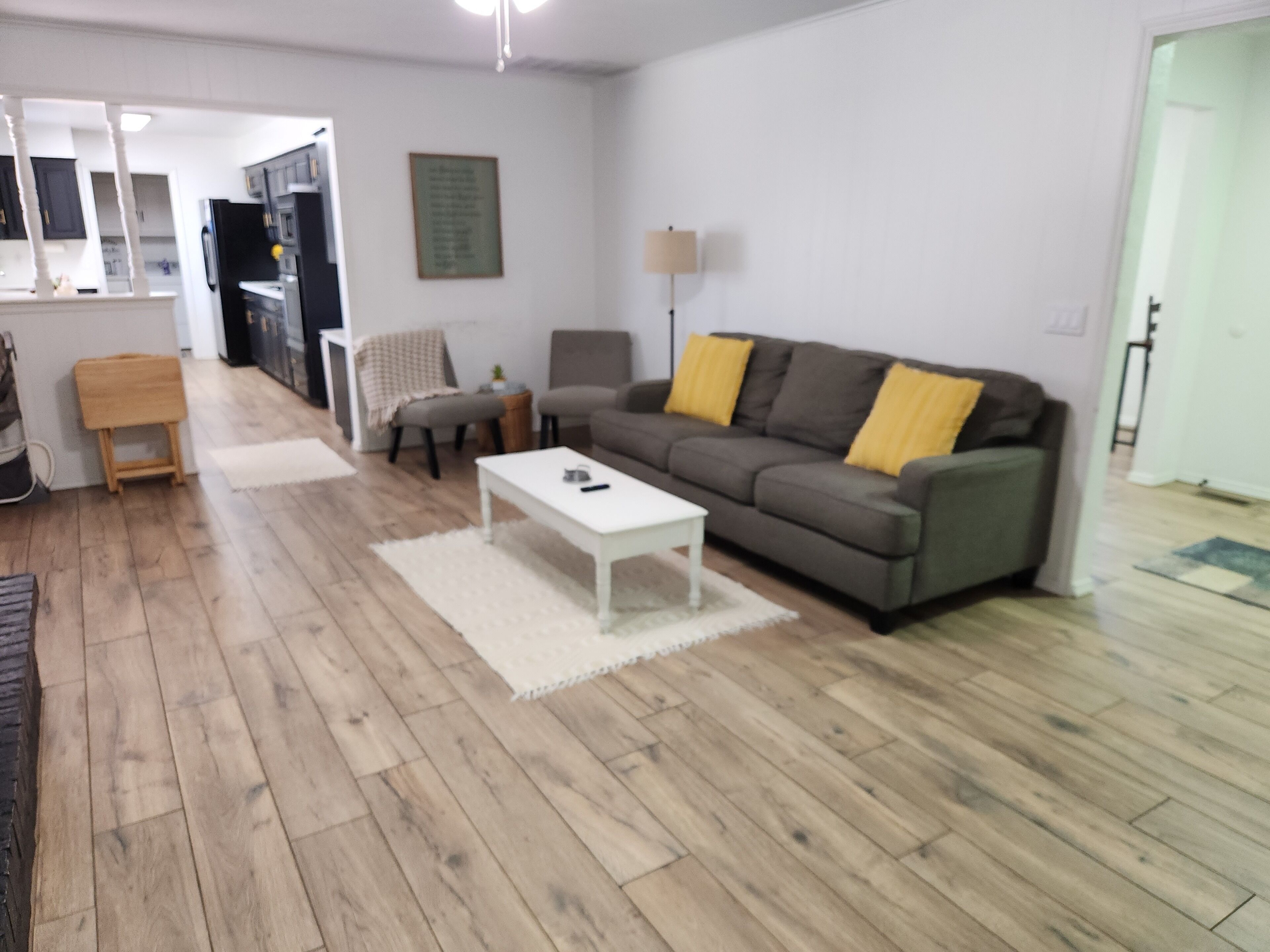 A living room with a sofa, a coffee table, and a lamp.
