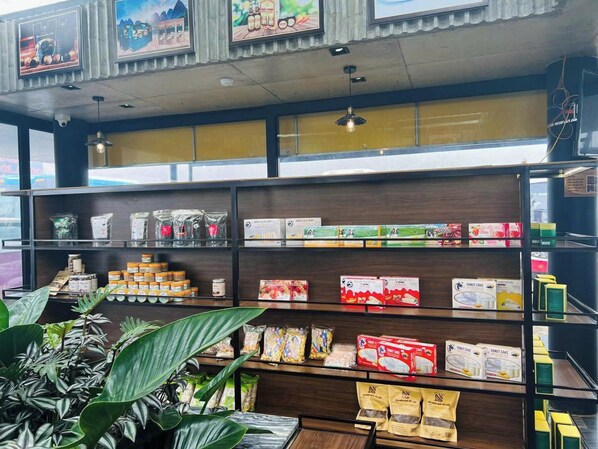 A store interior with shelves stocked with various packaged goods, including snacks and beverages. - Vigolando Van Ho Resort (Van Ho)