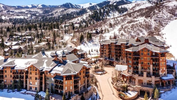 A large lodge with multiple buildings, a central courtyard, and a mountainous backdrop. - Abode at First Dawn, ski-in/ski-out, hot tub, sauna, resort access (Park City)