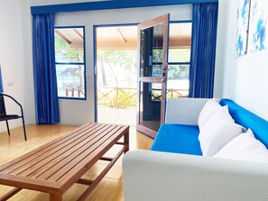 Deluxe Beachfront Suite | Zona de estar | Televisión LED de 32 pulgadas con canales por satélite, una televisión