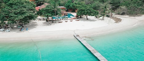 On the beach, white sand, sun loungers, beach towels