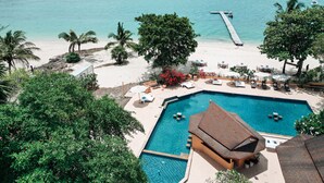 A resort with a swimming pool, beach, and a pier extending into the water. -  Cruiser Island Resort by Swiss-Belhotel (Koh Lon)
