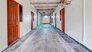 A long corridor with doors labeled 04 and 02, leading to rooms. - Hotel O Sari Laut (Temon)