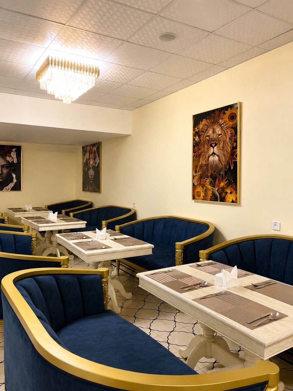 A restaurant interior with booths, tables, and artwork on the walls.
