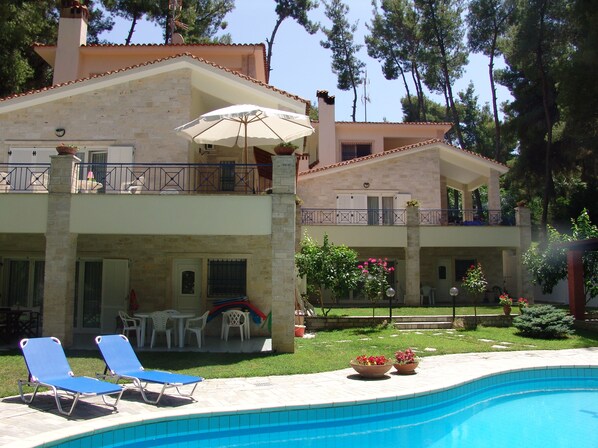 Enjoy a refreshing dip in the pool surrounded by a tranquil garden and comfortable seating areas.