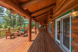 A wooden deck with outdoor seating and a bar area. - C & C Lodge (Clio)