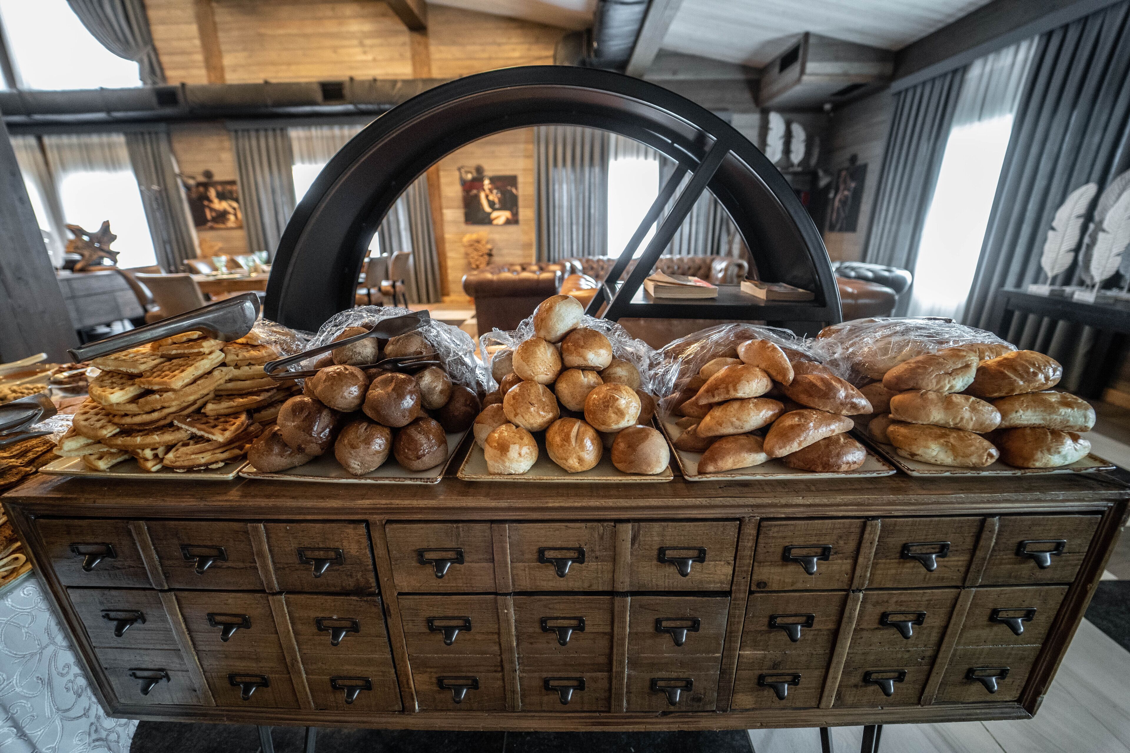 A bakery display with various baked goods in a rustic setting.