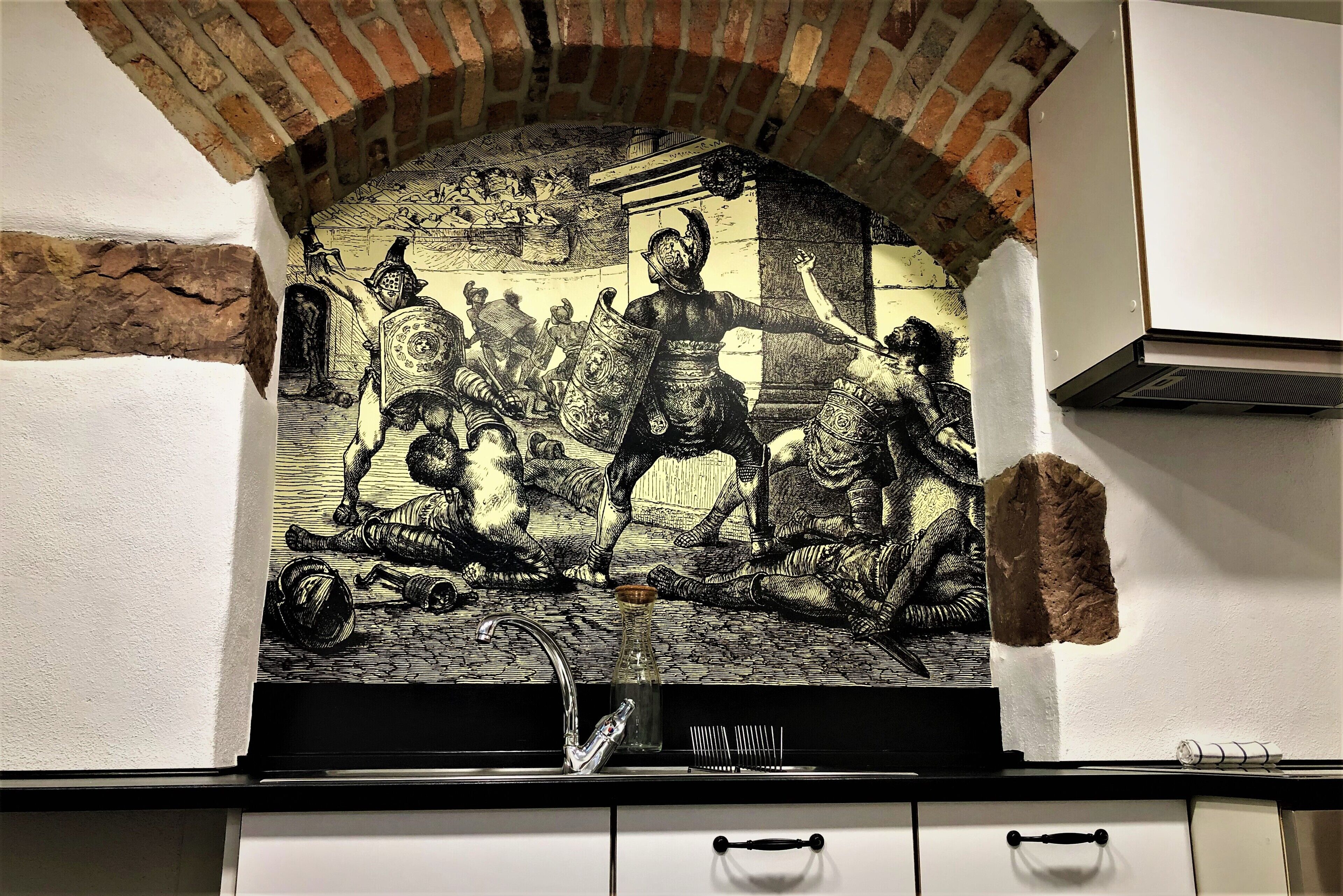 A kitchen with a mural depicting a historical battle scene.