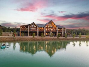 Exterior - The Clubhouse is a refined sanctuary where celebration and rest coexist effortlessly. A grand lodge designed for gatherings, it welcomes weddings beneath soft lights, laughter by the fire, and mornings that unfold slowly. (BROKEN BOW)