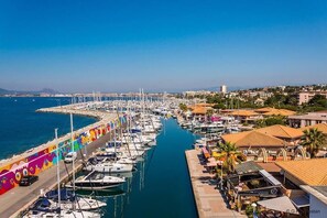 A marina with boats docked along a narrow waterway, surrounded by buildings and a clear sky. - Large seaside villa, facing Santa Lucia port, walking distance to city center (Saint-Raphaël)