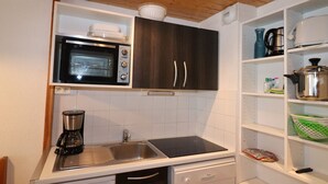 A compact kitchen with a microwave, a coffee maker, and a dishwasher. - Comfortable Apartment in Tignes, Pet Friendly (Tignes)