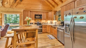 A wooden cabin kitchen with a wooden dining table, a refrigerator, and a microwave. -  Log cabin between Boone and Banner Elk-hot tub-game room-fire pit-private-cozy (Banner Elk)