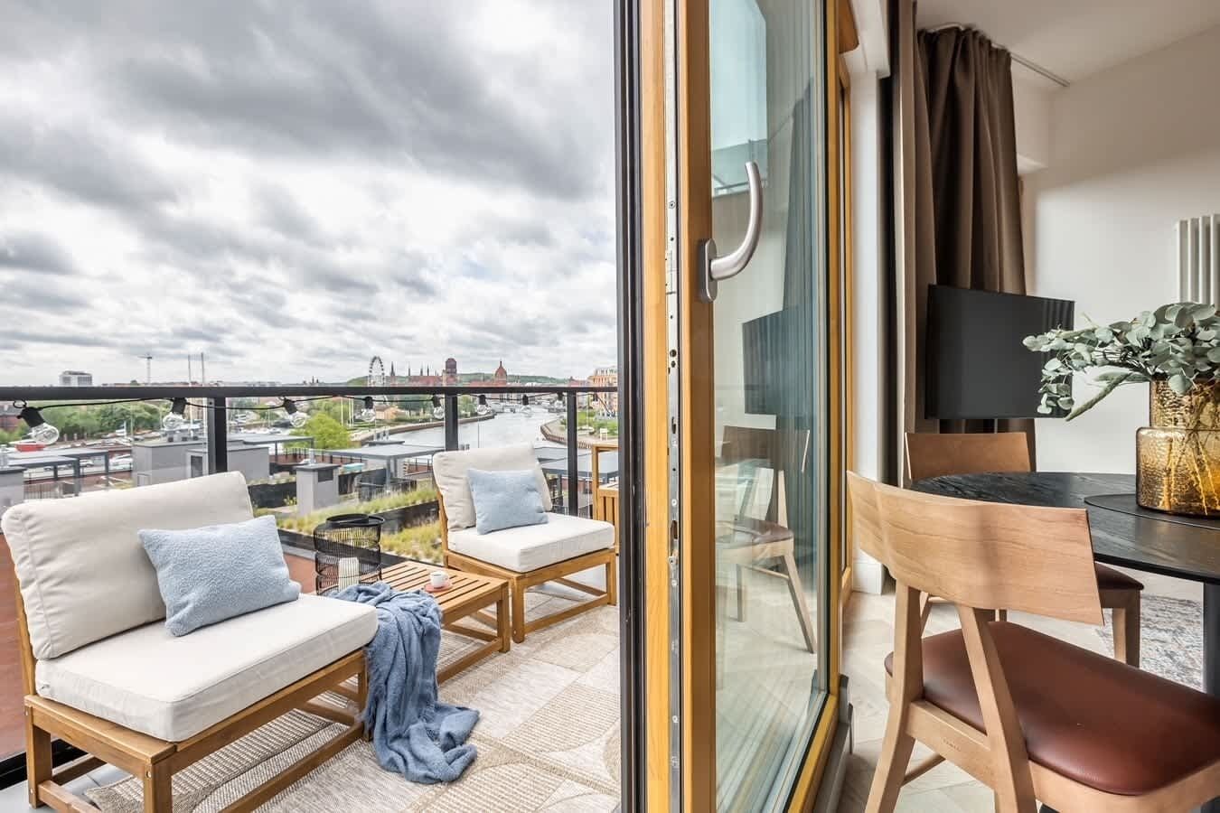 The balcony's stylish design complements the apartment's decor. 