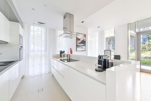 Luxury Apartment, 2 Bedrooms, Patio, Ground Floor | Private kitchen | Full-sized fridge, microwave, oven, stovetop - Elegant 2BR with maids room and Ain View (Dubai)