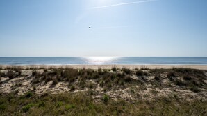 A beach with sand dunes and a clear sky. - Oceanfront 2 bedroom in desirable North OC (Ocean City)