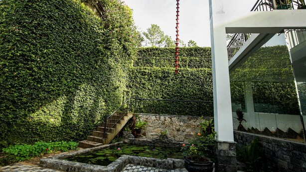 A stone staircase leading up to a white structure with a metal railing.