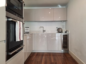 Enjoy cooking in this well-equipped kitchen with an oven, microwave, and stainless steel sink.