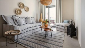 A modern living room with a sofa, a coffee table, and a decorative rug. - Naxos Blue Dream Villa With Pool (Naxos)