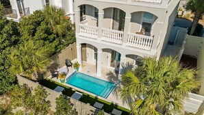 A multi-story building with a swimming pool surrounded by palm trees. - LSV/Golf Cart, Private Pool, Fire Pit! Steps to Beach! Central Seagrove! Gulf Views!! (Santa Rosa Beach)