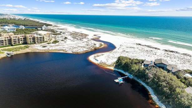 An aerial view of a coastal area with a large body of water, a beach, and a resort with multiple buildings. - LSV/Golf Cart, Private Pool, Fire Pit! Steps to Beach! Central Seagrove! Gulf Views!! (Santa Rosa Beach)